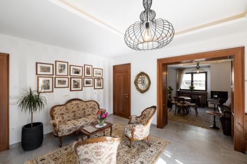 a living room with a couch and a table at Kotnik Superior Boutique Hotel in Kranjska Gora