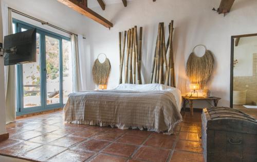 a bedroom with a bed and a large window at B&B Muse Marbella in Marbella
