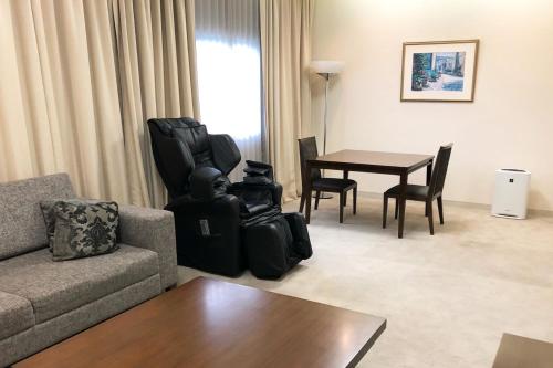 a living room with a couch and a table at Art Hotel Narita in Narita