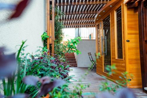 an open door to a patio with flowers and plants at Zamarin Hotel & Spa in Zikhron Ya‘aqov