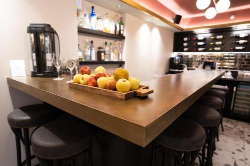 a bar with a tray of fruit on a counter at Zamarin Hotel & Spa in Zikhron Ya‘aqov