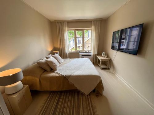 a small bedroom with a bed and a window at Banga & Sunrise Nida in Nida