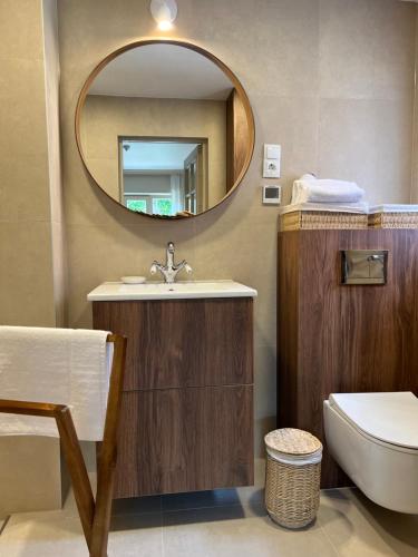a bathroom with a sink and a mirror at Banga & Sunrise Nida in Nida