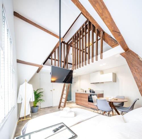 a loft conversion with a dining room and kitchen at New Family Penthouse 7Min from Rotterdam Central Station top floor app4 in Schiedam