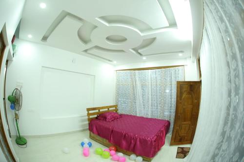 a bedroom with a bed in a room with a ceiling at Thodupuzha 4-bhk Luxury Home awy from home in Thodupuzha