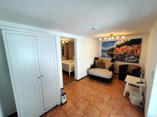 a small living room with a couch and a bed at Gästehaus Parkblick in Rust
