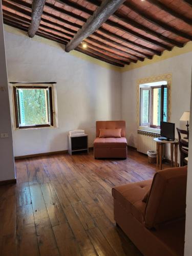 a living room with a couch and a table at Hotel Villa Casalecchi in Castellina in Chianti