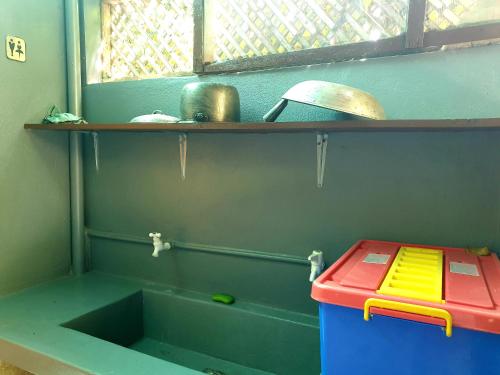 a toy kitchen with a sink and a shelf at MJ's Residences Garden Hotel in Moalboal