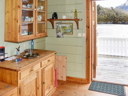 a kitchen with a counter and a door to a porch at 8 person holiday home in Ørskog-By Traum in Ørskog
