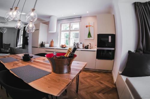 a kitchen and dining room with a wooden table at Vila Pražská in Vrchlabí
