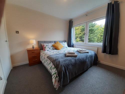 a small bedroom with a bed and a window at Carvetii - Zelda House - 4 bedroom house, sleeps 8 in Oakley