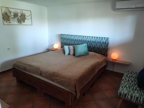 a bedroom with a large bed with a blue headboard at Apartman Dunav in Aljmaš