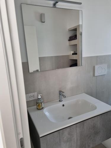 a bathroom with a white sink and a mirror at White House in Civitanova Marche