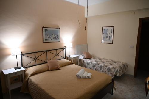 a bedroom with two beds and two shoes on the bed at Castello Di Sotto in Milazzo