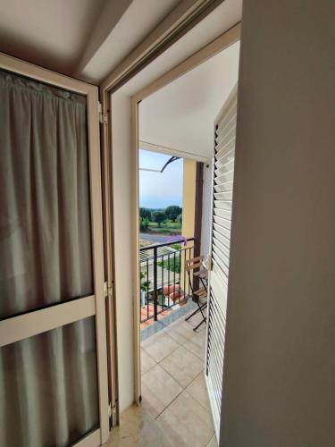 a room with a sliding glass door with a balcony at Gullo Capo Vaticano in Ricadi