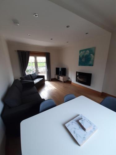 a living room with a couch and a table at Carvetii - Xavier House - 2-storey sleeps up to 7 in Rosyth