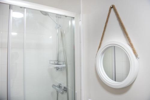 a bathroom with a mirror and a shower at Wheal Jewel- Beautifully Fitted Wooden Lodge Helston Cornwall in Helston
