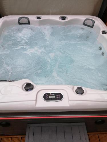 a jacuzzi tub with a clock in it at Lake District and Eden Valley Thornhill Lodge in Long Marton