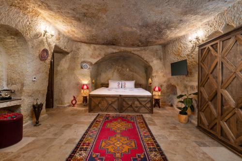 a bedroom with a bed in a stone room at Kayata Cave Suites Special Class in Urgup