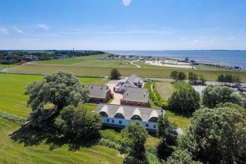 an aerial view of a large house in a field at Ferienanlage "Gut Tossens" in Tossenserdeich