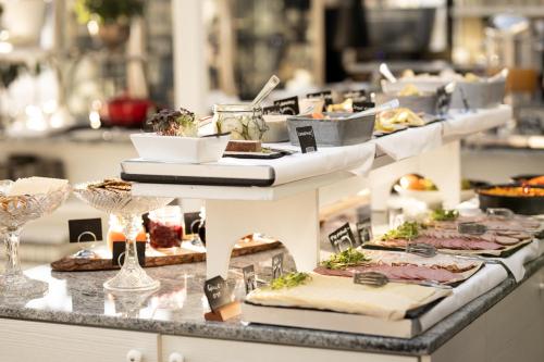 a buffet line with plates of food and drinks at Gränsö Slott Hotel & Spa in Västervik