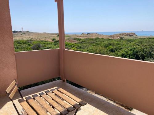 a bench on a balcony with a view of the ocean at Ariadne Apartments in Paphos City