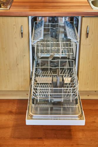 an open dishwasher with dishes inside of it at Chalet Haider in Saalbach Hinterglemm