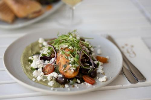 a plate of food on a table with a plate of food at Gränsö Slott Hotel & Spa in Västervik
