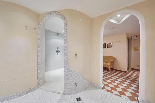 a bathroom with a mirror and a checkered floor at Chalet Haider in Saalbach Hinterglemm