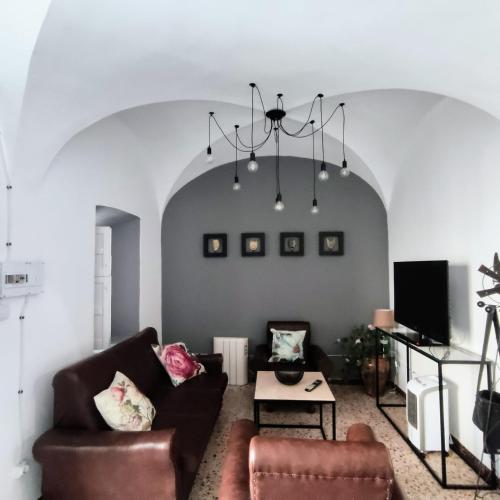 a living room with a couch and a chair at Casa Rural Maribel in Santa Amalia