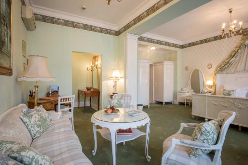 a living room with a couch and a table at Hotel Der Kleine Prinz in Baden-Baden