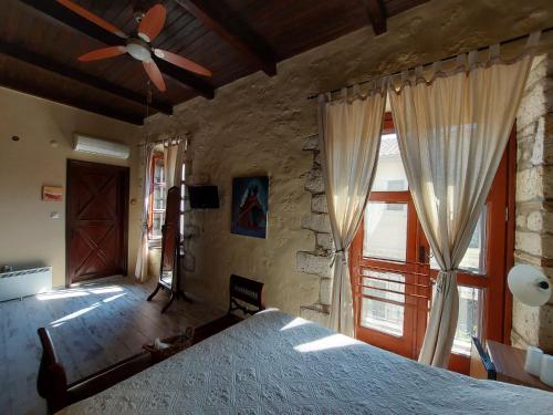 a bedroom with a large bed with a ceiling fan at 1882 Hotel in Alacati