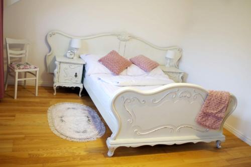 a white bed with pillows on it in a bedroom at zaKRZYWEk wyjątkowy apartament w Krzywe k/Cisnej in Cisna
