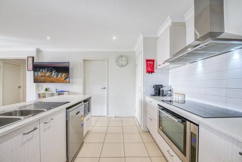 a kitchen with white cabinets and a counter top at Seabreeze Haven -Wifi, Netflix, pet friendly beach house in Cowes