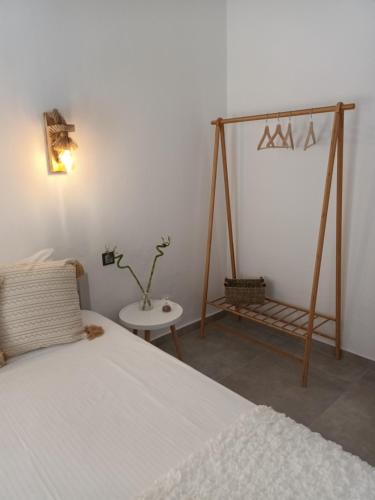 a bedroom with a bed and a table with a lamp at Maison Kalogiannis in Patitiri