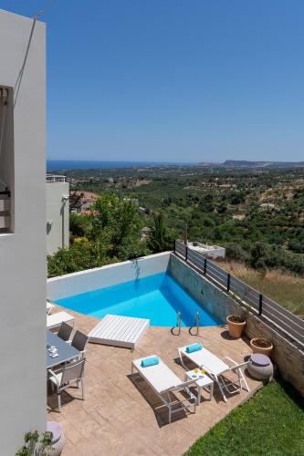 a swimming pool on the roof of a house at Linari Villa, a peaceful & cozy 2bdr villa with private pool! in Agia Triada