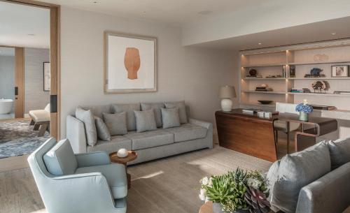 a living room with a couch and a table at Four Seasons Astir Palace Hotel Athens in Athens