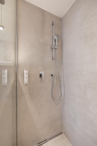 a shower with a glass door in a bathroom at Kotnik Superior Boutique Hotel in Kranjska Gora