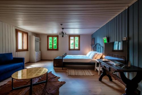 a bedroom with a bed and a couch and a table at Casa Bella Oschesina by Quokka 360 - in the village of Osco in Osco
