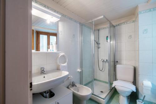 a bathroom with a sink and a toilet and a shower at Casa Bella Oschesina by Quokka 360 - in the village of Osco in Osco