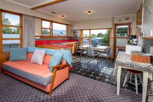 a living room with a couch and a kitchen at Grand View - Te Anau Holiday Home in Te Anau