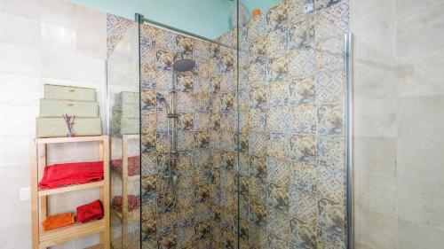 a bathroom with a shower with a glass door at Casa La Higuera Competa by Ruralidays in Frigiliana