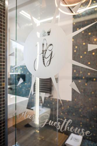 a glass window with a clock in front of a building at Helios Guest House in Cagliari