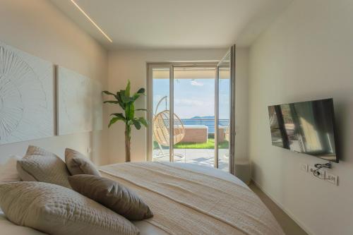 a bedroom with a bed with a view of the ocean at La Vista Bonita by Rent All Como in Como