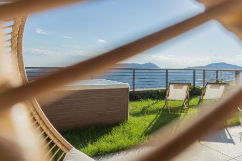 a hammock on a balcony with a view of the ocean at La Vista Bonita by Rent All Como in Como