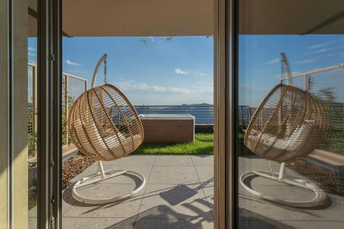 two baskets on a window with a view of the ocean at La Vista Bonita by Rent All Como in Como
