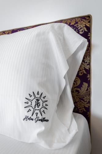 a white pillow with a new germination at Helios Guest House in Cagliari