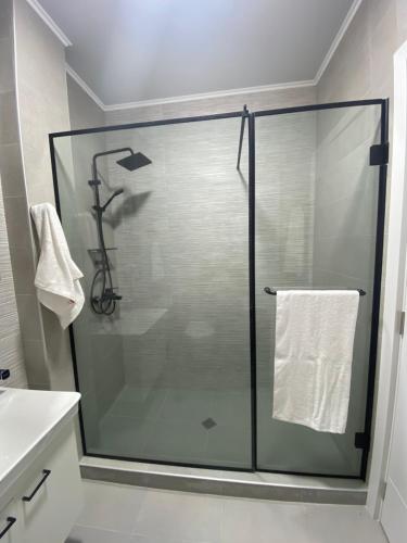 a shower with a glass door in a bathroom at Home № 1 in Kutaisi