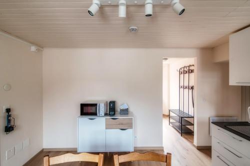 a kitchen with a refrigerator in the middle of a room at Casa Bella Oschesina by Quokka 360 - in the village of Osco in Osco
