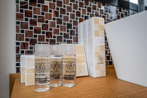 a table with two glasses and boxes on it at Helios Guest House in Cagliari